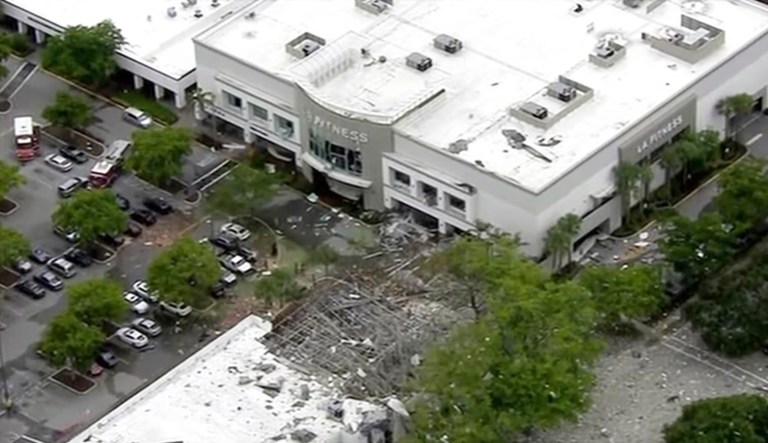 This image taken from video provided by WPLG shows debris covering the parking lot of a shopping center after an explosion on Saturday, July 6, 2019 in Plantation, Fla.