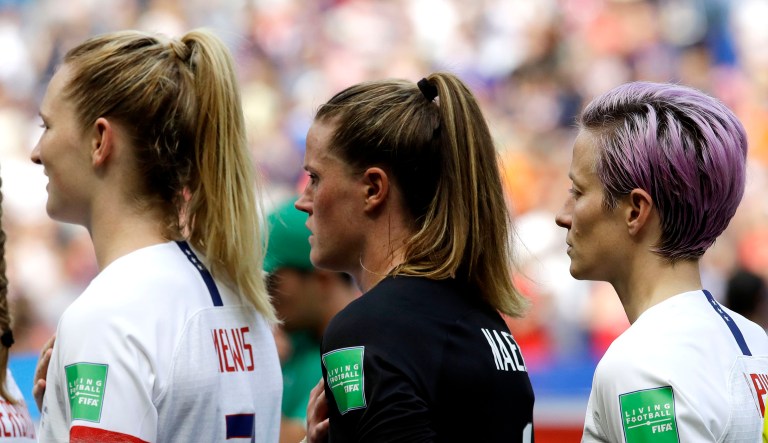 United States' Megan Rapinoe, right, and her teammates listen to their national anthem prior the Women's World Cup final soccer match between US and The Netherlands at the Stade de Lyon in Decines, outside Lyon, France.