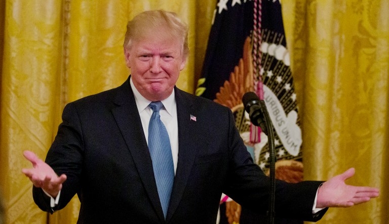 President Trump gestures at an event in the White House in Washington.