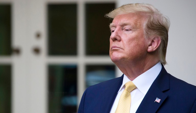 President Trump listens at an event in the White House in Washington. 