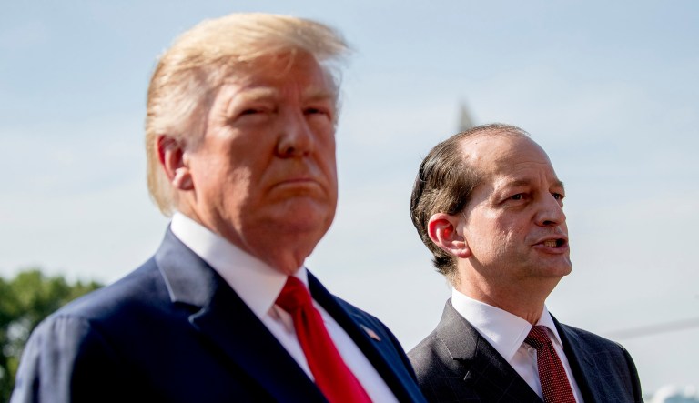 Labor Secretary Alex Acosta, right, accompanied by President Trump, left, speaks to members of the media on the South Lawn of the White House in Washington.