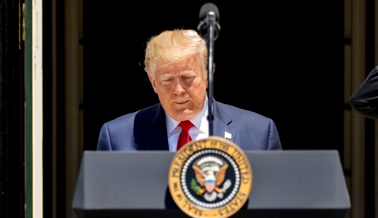 President Trump heads to the podium to speak at an event.