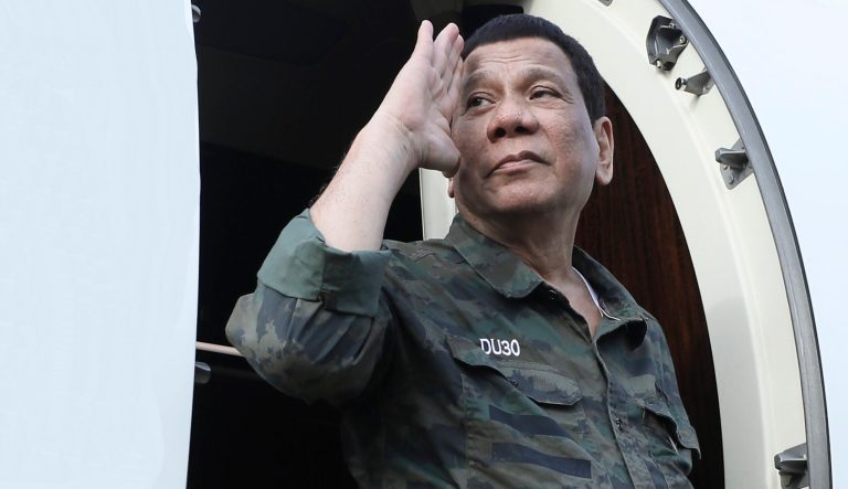 In this July 15, 2019, photo released by the Malacanang Presidential Photo, Philippine President Rodrigo Duterte returns a salute as he arrives at the Jolo airport, Sulu province, southern Philippines. 
