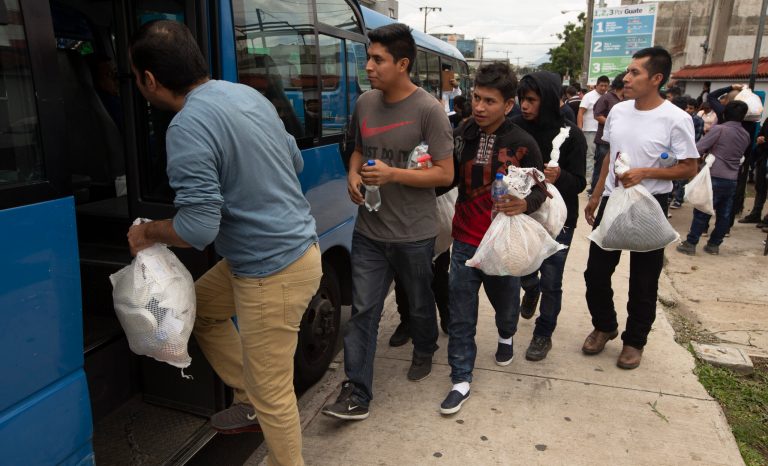 Guatemalan men who were deported from the United States, board a bus after arriving at the Air Force Base in Guatemala City, Tuesday, July 16, 2019. 