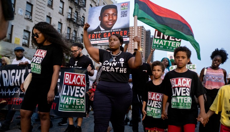 Activists with Black Lives Matter protest in the Harlem neighborhood of New York, Tuesday, July 16, 2019, in the wake of a decision by federal prosecutors who declined to bring civil rights charges against New York City police Officer Daniel Pantaleo, in the 2014 chokehold death of Eric Garner. 
