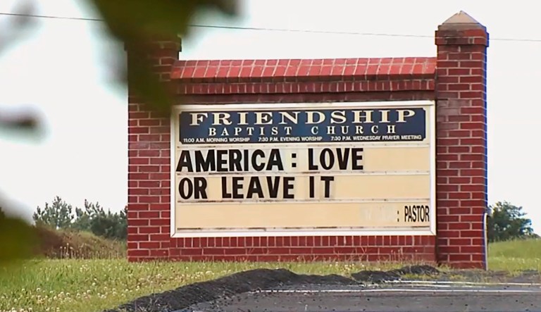This image taken from video provided by WSET-TV shows a sign saying, "America: Love it or Leave It," posted outside the Friendship Baptist Church in Appomattox, Virginia.