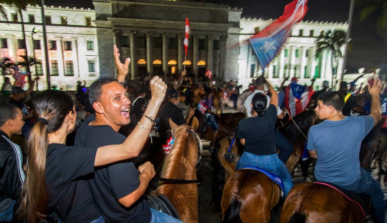 Demonstrators on horse back protest against governor Ricardo Rossello, in San Juan, Puerto Rico.