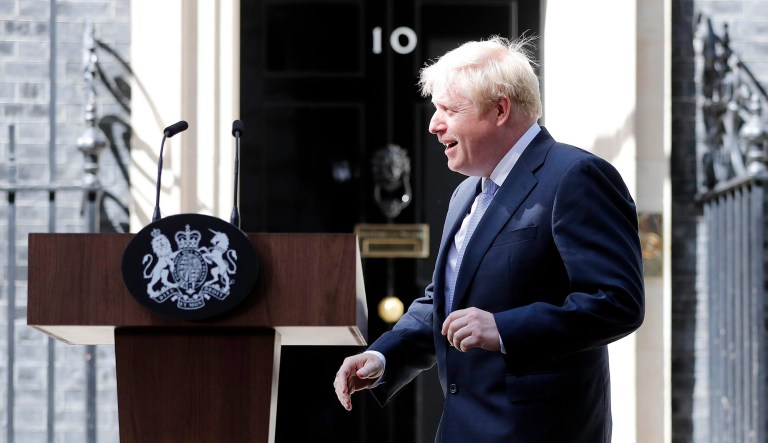 Britain's new Prime Minister Boris Johnson walks toward the lectern to speak outside 10 Downing Street, London.
