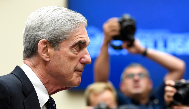 Former special counsel Robert Mueller returns to the witness table following a break in his testimony before the House Intelligence Committee on Capitol Hill in Washington.