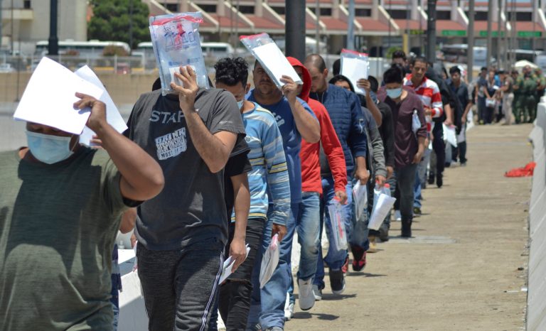 United States Border Patrol officers return a group of migrants back to the Mexico side of the border as Mexican immigration officials check the list, in Nuevo Laredo, Mexico, Thursday, July 25, 2019. 