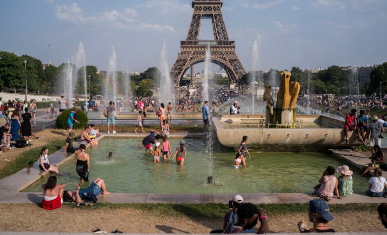 People enjoy the sun and the fountains of the Trocadero gardens in Paris, Thursday July 25, 2019, when a new all-time high temperature of 42.6 degrees Celsius (108.7 F) hit the French capital. 
