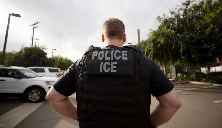 AU.S. Immigration and Customs Enforcement officer looks on during an operation in Escondido, California.