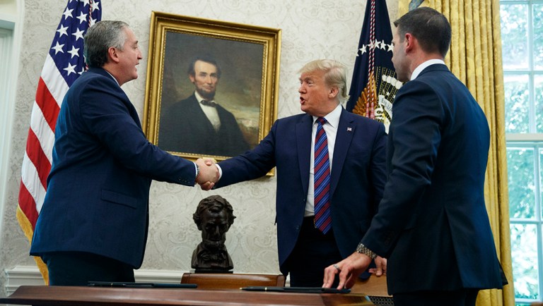 President Trump, joined by acting Department of Homeland Security Secretary Kevin McAleenan, right, shakes hands with Guatemalan Interior Minister Enrique Degenhart.