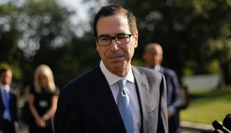 In this July 24, 2019 photo Treasury Secretary Steve Mnuchin walks away from the microphones after speaking to members of the media at the White House in Washington. 
