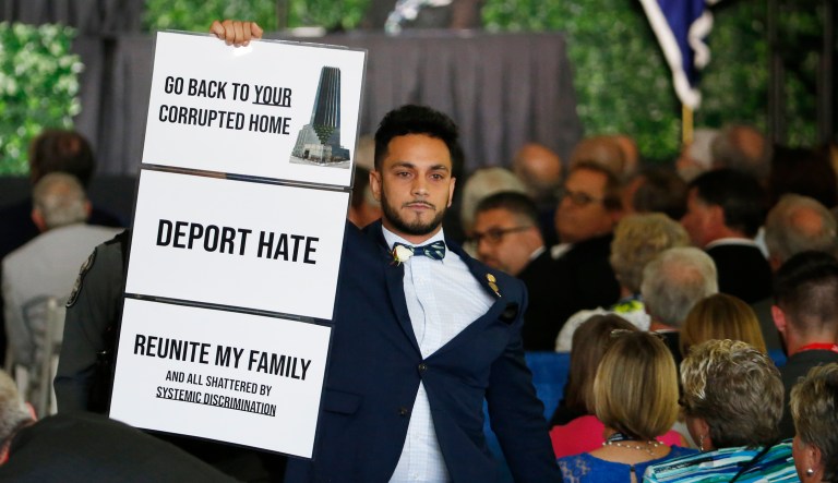 Virginia Delegate Ibraheem S. Samirah,  D-Fairfax, is escorted out of the venue after interrupting the speech of President Trump during a commemorative meeting of the Virginia General Assembly at Jamestown Settlement on the 400th anniversary of the meeting of the original House of Burgesses in Jamestown, Virginia.