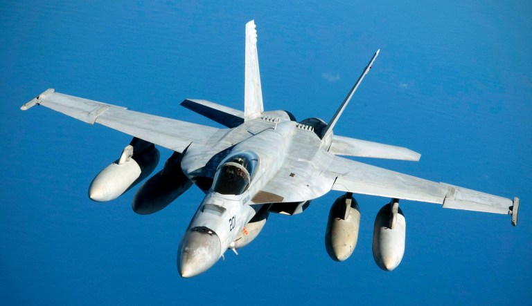 A Navy F/A-18 Super Hornet flies near Australia.