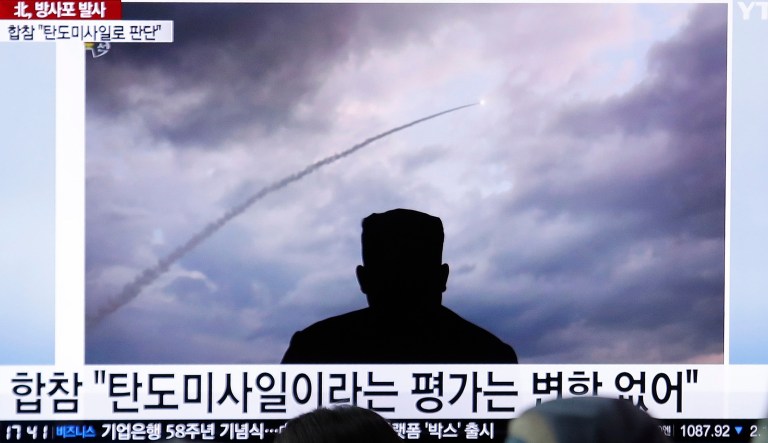 People watch a TV showing an image of North Korea's multiple rocket launch during a news program at the Seoul Railway Station in Seoul, South Korea, Thursday, Aug. 1, 2019. North Korea said Thursday leader Kim Jong Un supervised the first test firing of a new multiple rocket launcher system that could potentially enhance its ability to strike targets in South Korea and U.S. military bases there. The signs read: "Ballistic missiles." 