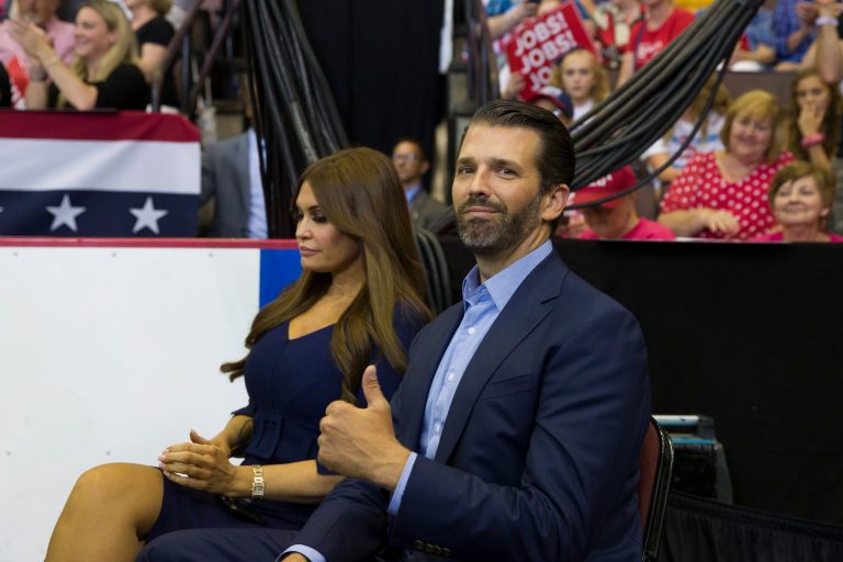 Donald Trump Jr., with girlfriend Kimberly Guilfoyle, gives a thumbs up as President Donald Trump speaks at a campaign rally Thursday, Aug. 1, 2019, in Cincinnati.