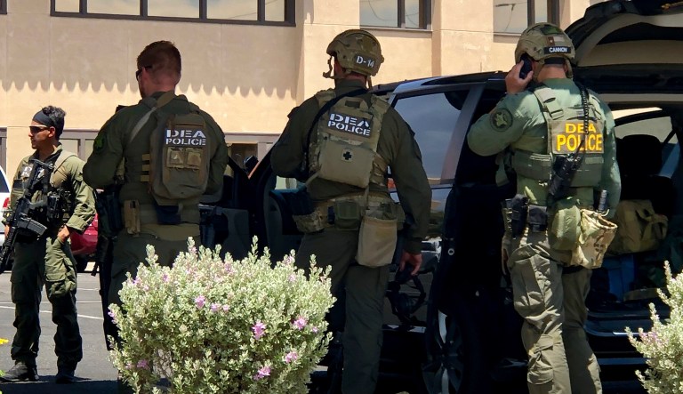 Law enforcement from different agencies work the scene of a shooting at a shopping mall in El Paso, Texas, on Saturday, Aug. 3, 2019. Multiple people were killed and one person was in custody after a shooter went on a rampage at a shopping mall, police in the Texas border town of El Paso said. 