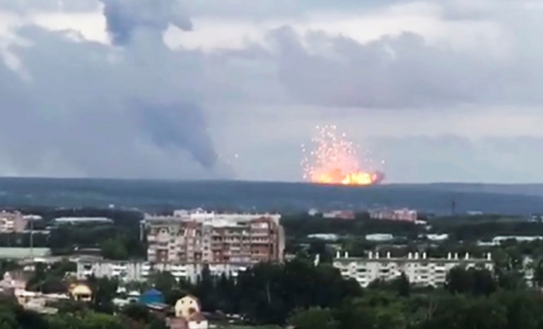 In this image taken from video, explosions are seen at the military base, about 10 kilometers from Achinsk, Krasnoyarsk region, Russia Far East, Monday, Aug. 5, 2019. 