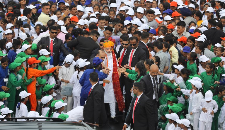 Indian Prime Minister Narendra Modi, center wearing turban, greets school children after addressing the nation on the country's Independence Day from the ramparts of Mughal-era Red Fort, in New Delhi, India.