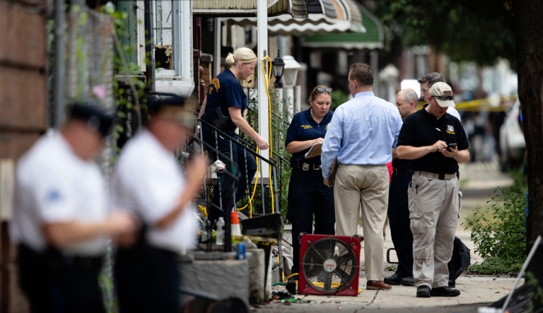 Officers conduct an investigation at the scene of Wednesday's standoff with police in Philadelphia.
