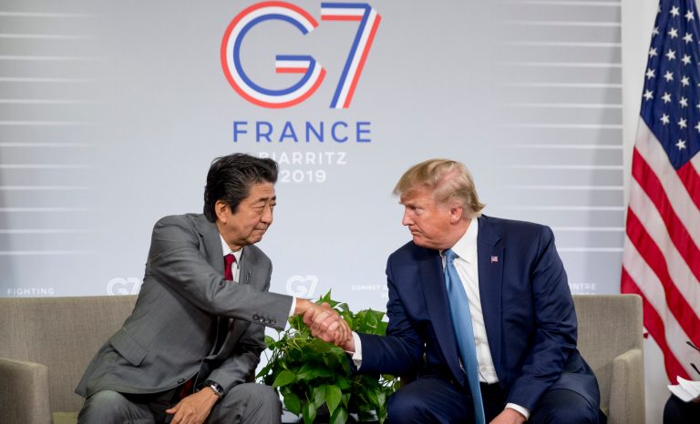 U.S President Donald Trump and Japanese Prime Minister Shinzo Abe, left, shake hands during a news conference at the G-7 summit in Biarritz, France, Sunday, Aug. 25, 2019, to announce that the U.S. and Japan have agreed in principle on a new trade agreement. 