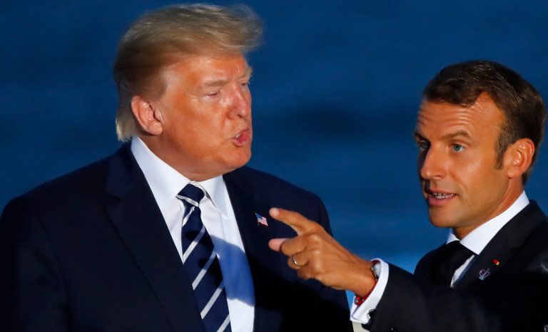 U.S President Donald Trump talks to French President Emmanuel Macron during the G7 family photo Sunday, Aug. 25, 2019 in Biarritz.