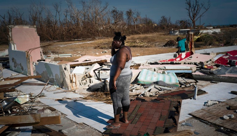 A woman is overcome as she looks at her house destroyed by Hurricane Dorian, in High Rock, Grand Bahama, Bahamas, Friday. The Bahamian health ministry said helicopters and boats are on the way to help people in affected areas, though officials warned of delays because of severe flooding and limited access. 