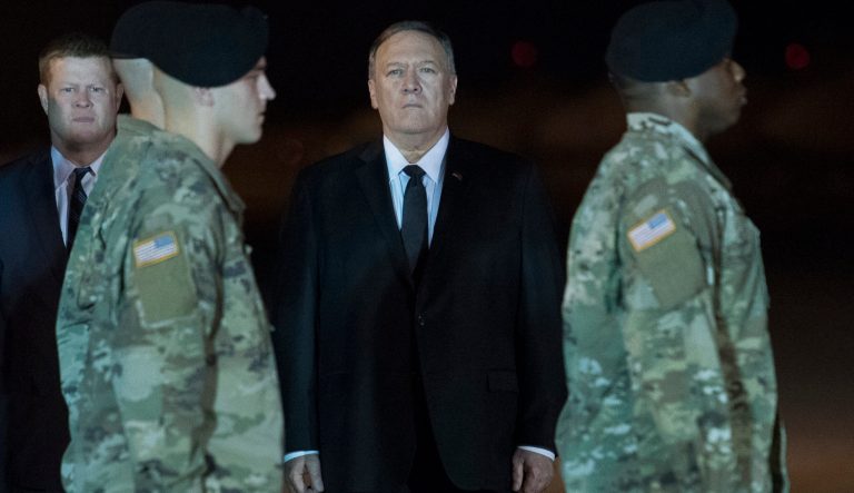 Ryan McCarthy, Acting Secretary of the Army, left, and Secretary of State Mike Pompeo, right, stand behind the Army Carry Team while they participate in the Dignified Return of Sgt. 1st Class Elis Barreto Ortiz, 34, from Morovis, Puerto Rico, Saturday, Sept. 7, 2019, at Dover Air Force Base, Del. 