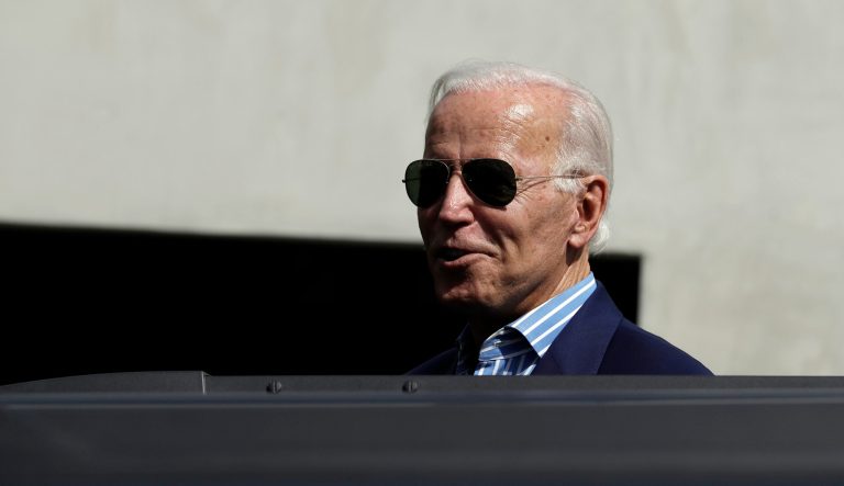Democratic presidential candidate former Vice President Joe Biden peeks out of the roof of an SUV to speak to reporters as he leaves a fundraiser appearance Wednesday, Sept. 25, 2019, in Manhattan Beach, Calif. 