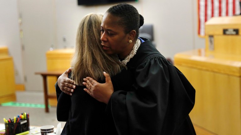State District Judge Tammy Kemp gives former Dallas Police Officer Amber Guyger a hug before Guyger leaves for jail, Wednesday, Oct. 2, 2019, in Dallas. Guyger, who said she mistook neighbor Botham Jean's apartment for her own and fatally shot him in his living room, was sentenced to a decade in prison. 