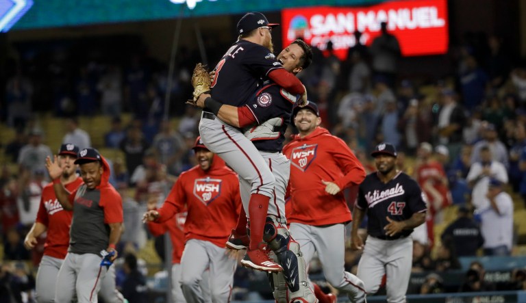 Washington Nationals pitcher Sean Doolittle, left, and catcher Yan Gomes leap in celebration after the team's 7-3 win in Game 5 of a baseball National League Division Series against the Los Angeles Dodgers on Wednesday, Oct. 9, 2019, in Los Angeles. 