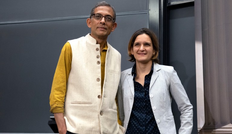 Esther Duflo, left, and Abhijit Banerjee stand together following a news conference at Massachusetts Institute of Technology in Cambridge, Mass., Monday, Oct. 14, 2019. 