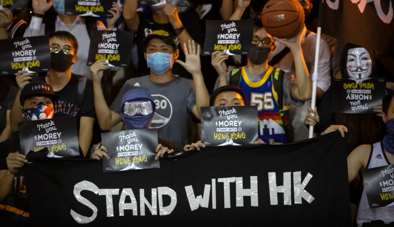 Demonstrators hold up signs in support of Houston Rockets general manager Daryl Morey during a rally at the Southorn Playground in Hong Kong, Tuesday, Oct. 15, 2019. 