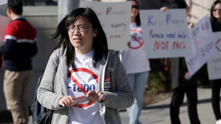 In this photo taken Oct. 11, 2019, Linda Yang, of the 'Let People Vote' campaign, is seen at a demonstration against I-1000, in Bellevue, Washington. 
