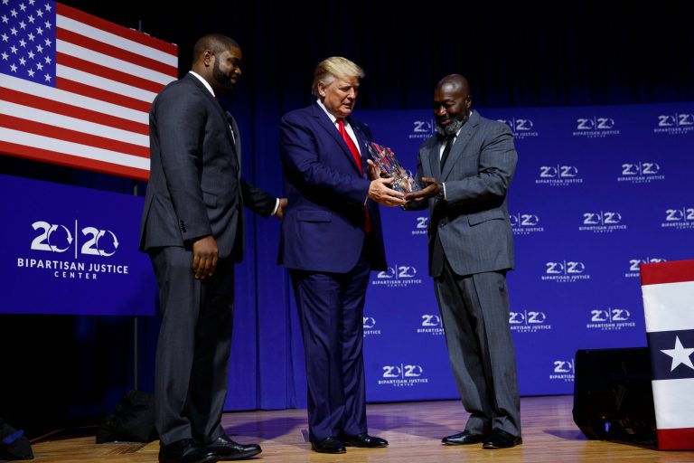President Donald Trump is awarded the Bipartisan Justice Award by Matthew Charles, right, one of the first prisoners released by the First Step Act, during the "2019 Second Step Presidential Justice Forum" at Benedict College, Friday, Oct. 25, 2019, in Columbia, S.C.