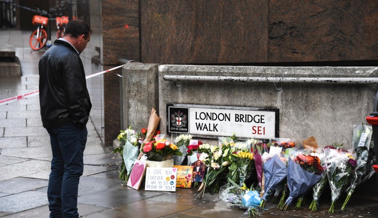 Flowers and a pictures are left in memory of Jack Merritt who has been named as the first victim of Friday's terror attack on London Bridge in London, Sunday, Dec. 1, 2019. 