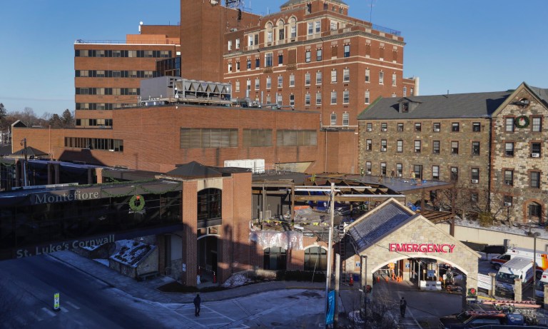 In this Thursday, Dec. 19, 2019 photo, pedestrians pass St. Luke's Cornwall Hospital in Newburgh, N.Y. The hospital adopted the Hudson Valley Interlink Analytic System earlier this year, which tracks drug overdoses in New York. The system is among a number of surveillance systems being adopted around the country by police, government agencies and community groups.