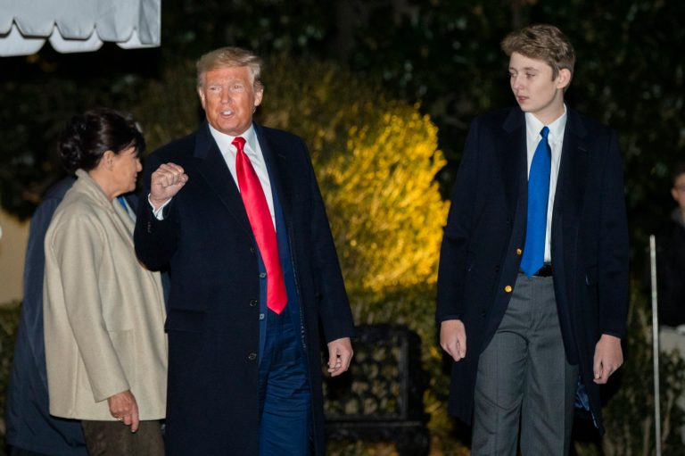 President Donald Trump with his son Barron Trump gestures as they leave the White House, Friday, Dec. 20, 2019, in Washington, on their way to their holiday vacation at his Mar-a-Lago estate in Palm Beach, Fla. Following them on the left is Melania Trump's mother Amalija Knavs.