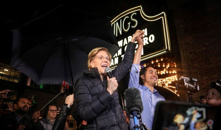 Democratic presidential candidate Sen. Elizabeth Warren, D-Mass., center, raises the hand of former Secretary of Housing and Urban Development and presidential candidate Julian Castro, as she arrives for a rally, Tuesday, Jan. 7, 2020, during a campaign stop at Brooklyn's King Theatre in New York.