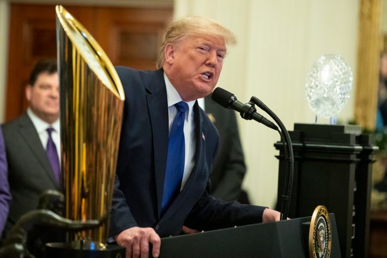 Trump stokes backlash after poking fun at himself during visit with LSU football team