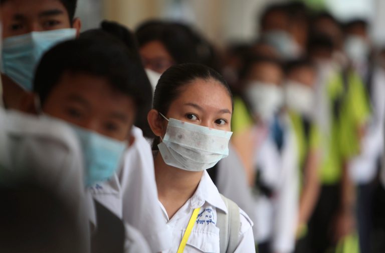 Students line up to sanitize their hands to avoid the contact of coronavirus before their morning class at a hight school in Phnom Penh, Cambodia, Tuesday, Jan. 28, 2020. China on Tuesday reported 25 more deaths from a new viral disease, as the U.S. government prepared to fly Americans out of the city at the center of the outbreak. 