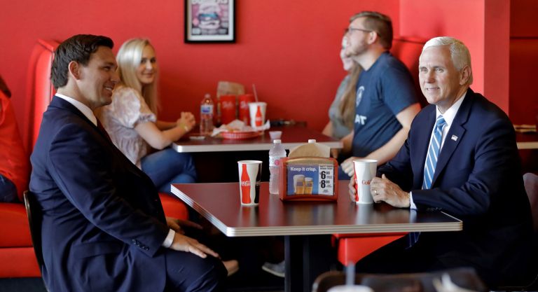 A public return to normalcy: Pence chows at a Florida burger joint with Trump ally DeSantis