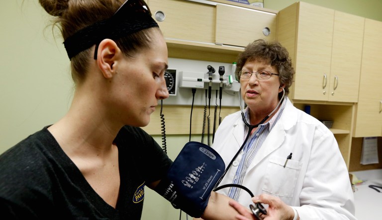 Family Nurse Practitioner Ruth Wiley examines Elizabeth Knowles (left) at a clinic.