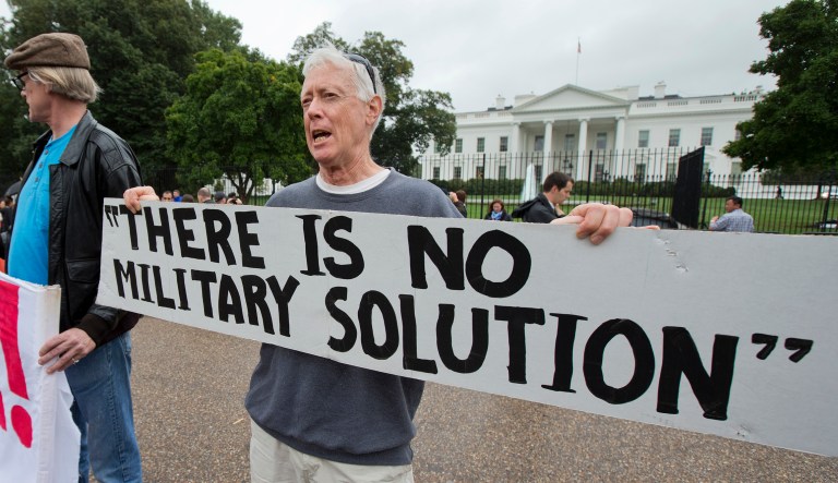 David Barrows join other protesters in front of the White House in Washington, Thursday, Sept. 25, 2014, to protest the U.S. bombing of Syria.