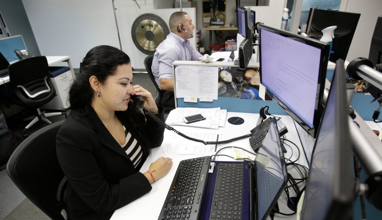 Karen Gonzales, a recruiter with a temporary staffing company, talks on the phone from her Miami Lakes, Fla., office.