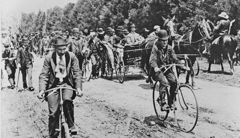 One of the largest armies of unemployed men parade in Washington, D.C., on bike, wagons, and on foot, on the first Labor Day observance, Sept. 3, 1894. Shown are Jacob S. Coxey's "Army of the Commonweal of Christ," with Coxey in the buggy  at right, wearing a light suit.