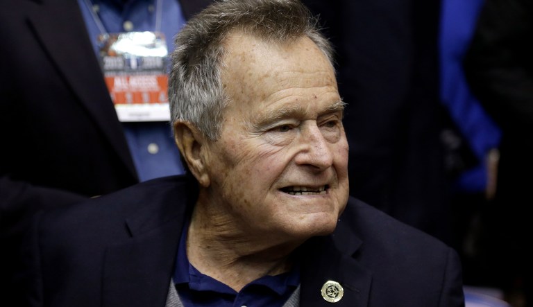Former President George H.W. Bush watches prior to an NCAA college basketball game between Duke and North Carolina State at Cameron Indoor Stadium in Durham, N.C., Saturday, Jan. 18, 2014.