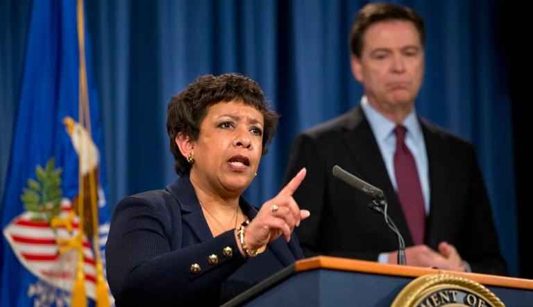 Former Attorney General Loretta Lynch, accompanied by FBI Director James Comey, speaks during a news conference at the Justice Department in Washington.  